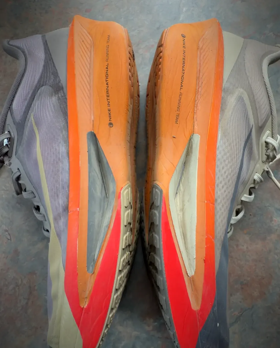 Outsole of a used pair of Nike Zoom Fly 6, showing rubber wear and the exposed foam sections